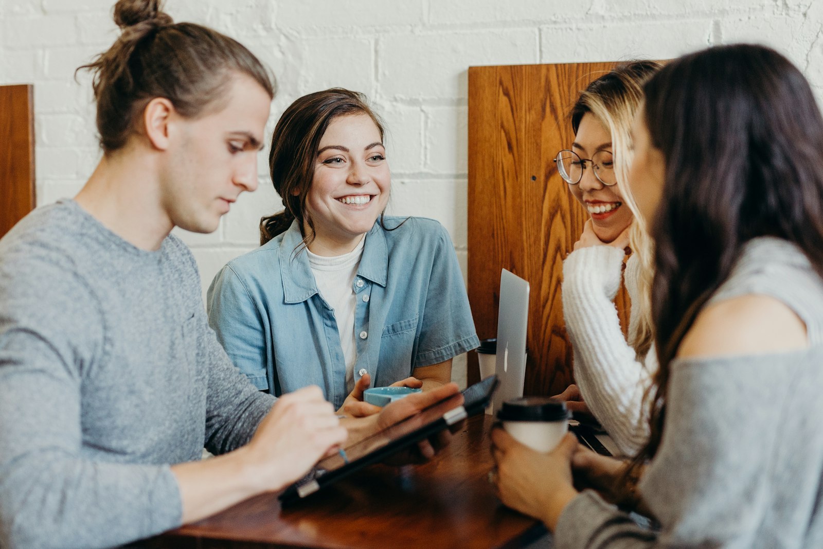 Small team collaborating together—laptop screen facing away